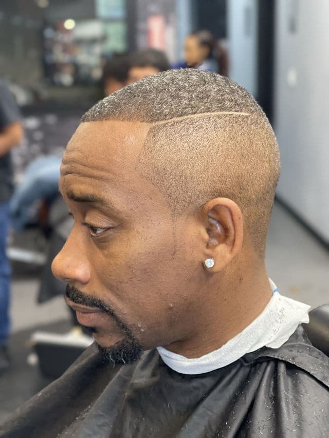 Bald fade with line design at Paramount Styles